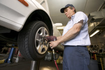 Auto repair man changing tire